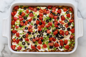 Step 10 how to make easy mexican casserole with corn tortillas, Sprinkle olives, green onion, and tomatoes
