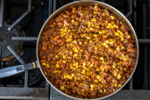 Step 3 how to make easy mexican casserole with tortillas, Stir in chili beans and corn and cook
