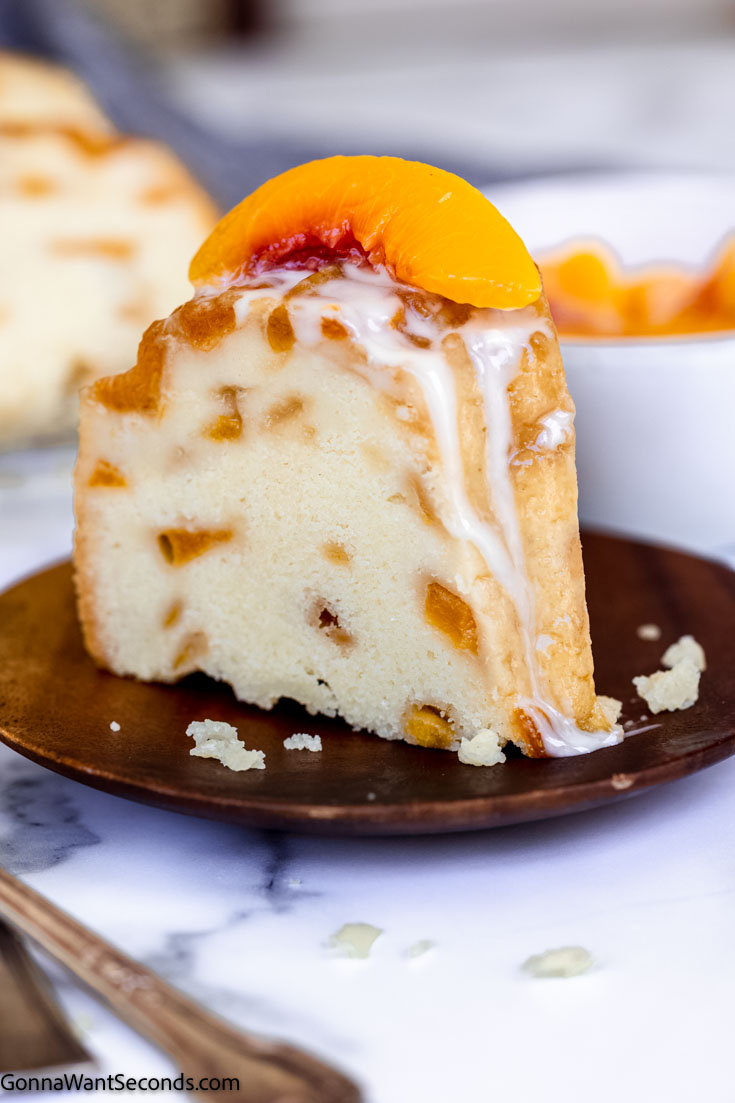 a slice of peach cobbler cake recipe with peach on top