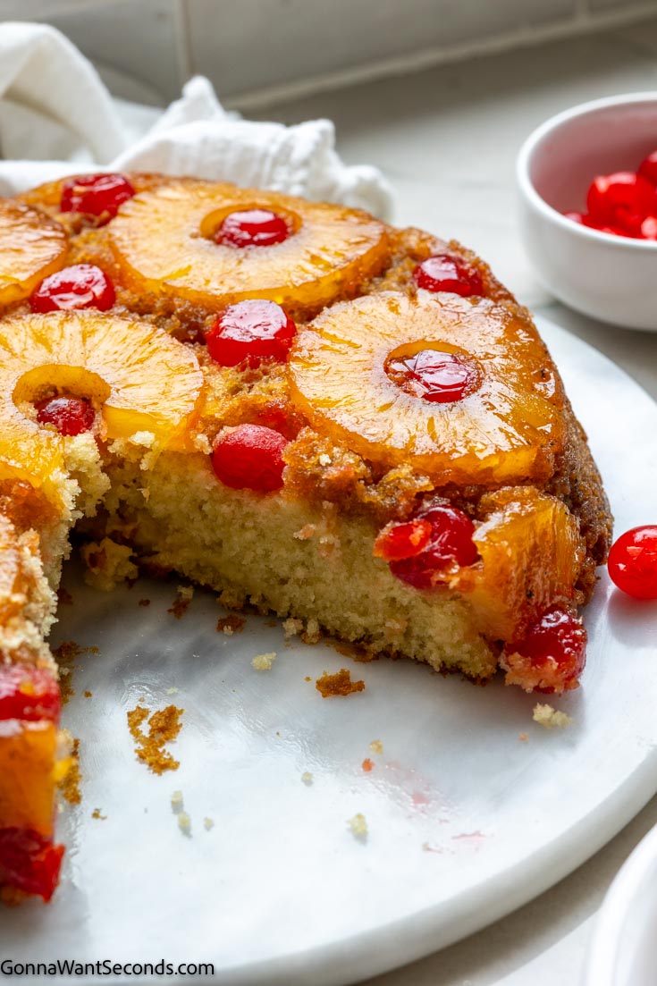 whole pineapple upside down cake with a slice cut out