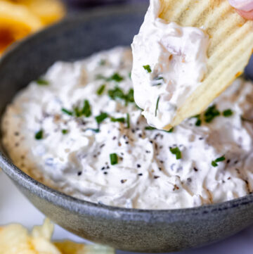 dipping chips in sour cream and onion dip