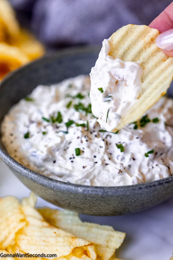 dipping chips in sour cream and onion dip