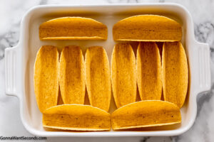 Step 4 how to make spaghetti with taco seasoning, arrange the taco shells in a baking dish