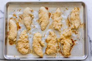 Step 5 how to make Bisquick chicken fingers, drizzle melted butter over chicken strips