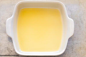 Step 3 how to make butter swim biscuits, add melted butter to the baking dish