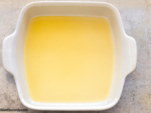 Step 3 how to make butter swim biscuits, add melted butter to the baking dish