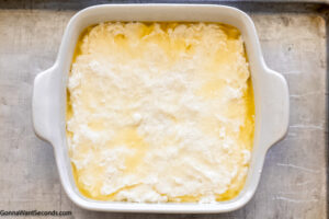 Step 4 how to make butter swim biscuits, add the dough on top of the butter