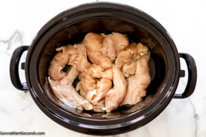 Step 1 how to make garlic parmesan chicken pasta, place chicken in the crockpot