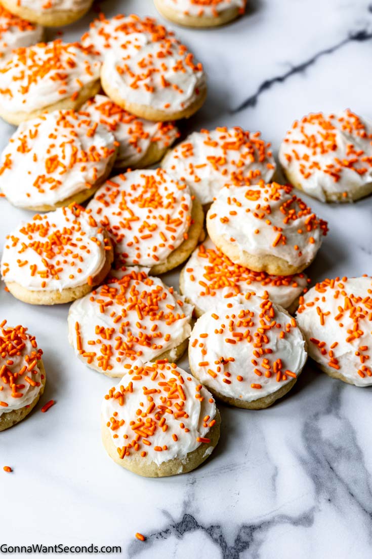 orange sugar cookies with frosting and sprinkles
