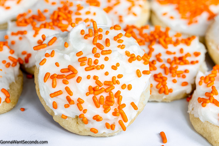 orange drop cookies with frosting and sprinkles