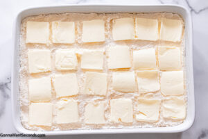Step 4 how to make pineapple dump cake, Arrange butter slices over the cake mix.