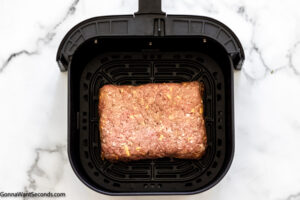 Step 6 how to make air fryer meatloaf with glaze, Place loaf in the air fryer basket. Cook.