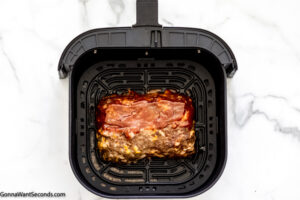 Step 7 how to make air fryer meatloaf, Brush the glaze on top and sides of the loaf, cook for 5 minutes.