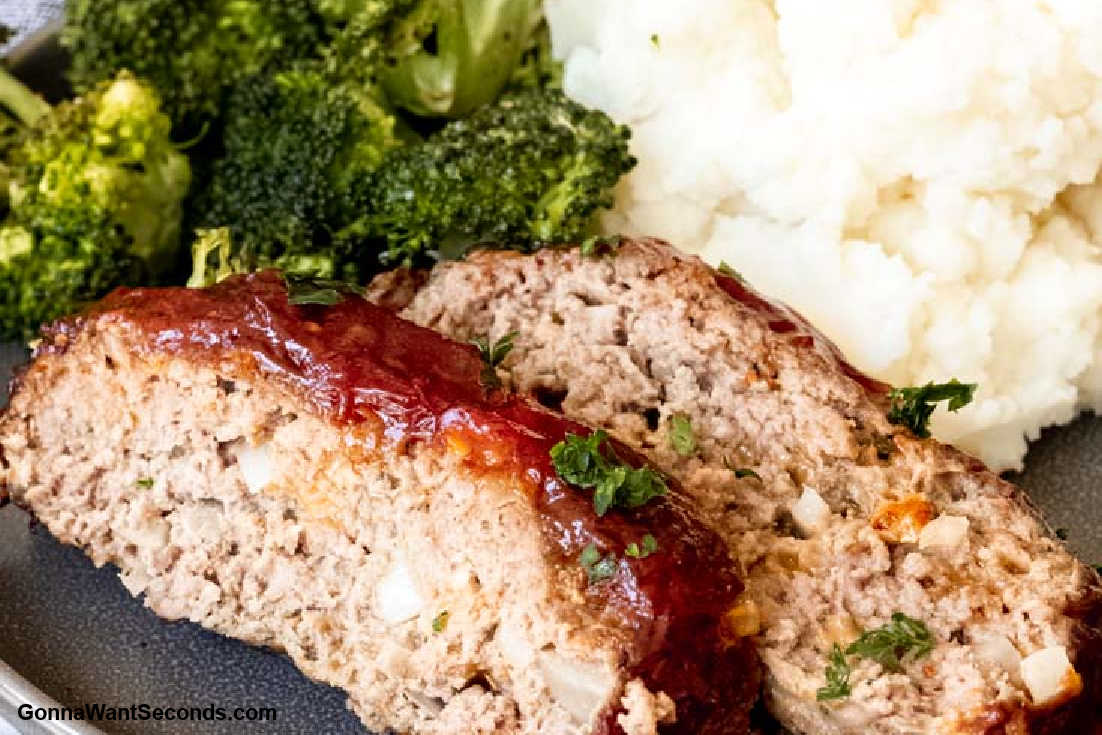 Slices of air fryer meatloaf with glaze with mashed potatoes and broccoli on a plate