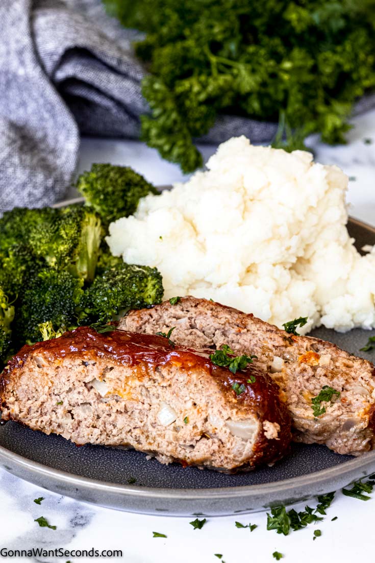 Slices of air fryer meatloaf with mashed potatoes and broccoli on a plate