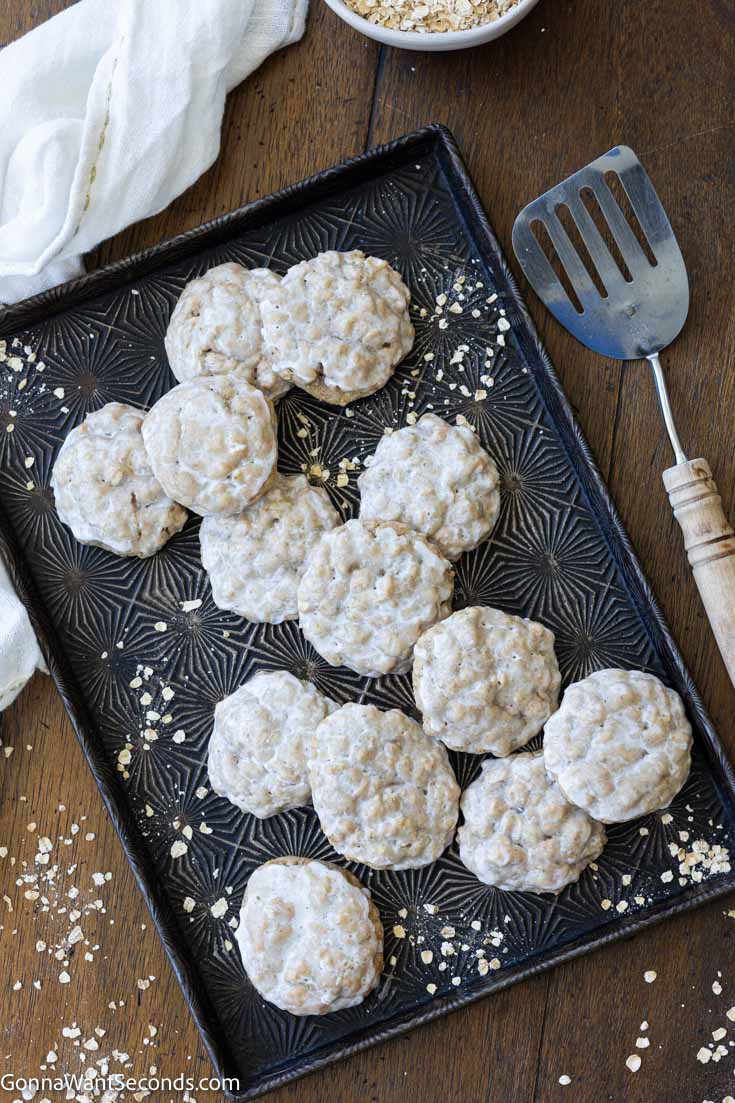 iced oatmeal cookies on a sheet pan