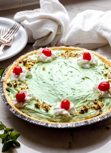 whole pistachio pie topped with cherries