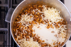 Step 6 how to make one pot taco mac, add jack cheese and heavy cream