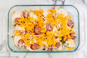 Step 6 how to make pierogi casserole with alfredo sauce , sprinkle half of the cheddar cheese