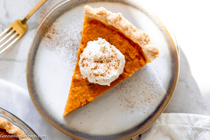 classic sweet potato pie with whipped cream on top, top shot