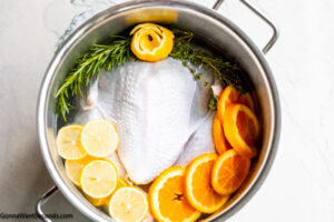 Step 3 how to make turkey brine with oranges, place the turkey in a pot. Add water and the rest of the ingredients. Place in the fridge.