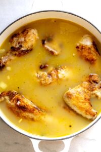 Step 9 how to make homemade chicken and dumplings, Return the chicken to the pan, and simmer until the chicken is falling off the bones.