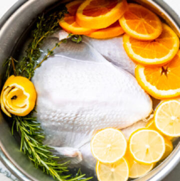 turkey brine with fresh herbs and citrus in a pot