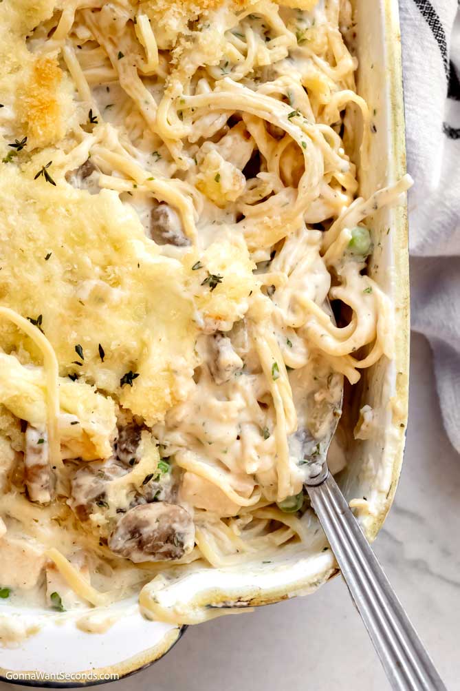turkey tetrazzini topped with melted cheese in a casserole dish