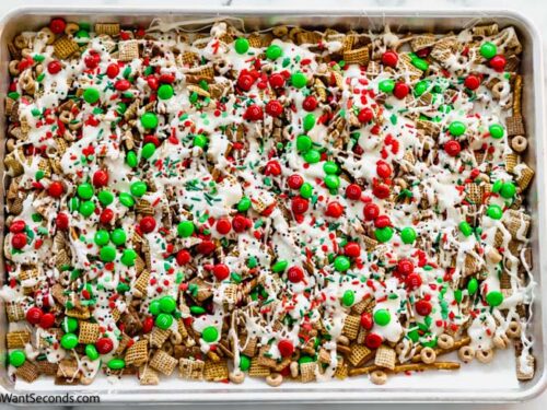 Step 3 how to make Christmas Crack Chex Mix, Step 1 how to make Christmas Chex Mix, Spoon the melted chocolate mixture over the cereal mix. Top with the remaining M&M's and holiday sprinkles.