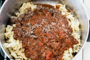Step 4 how to make lazy lasagna casserole, pour the sauce over the cooked pasta and toss to coat