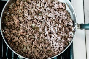 Step 2 how to make lazy lasagna casserole, add the ground beef and cook until browned