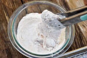 Step 7 how to make air fryer chicken, Dip again into the flour mixture, shaking off excess.