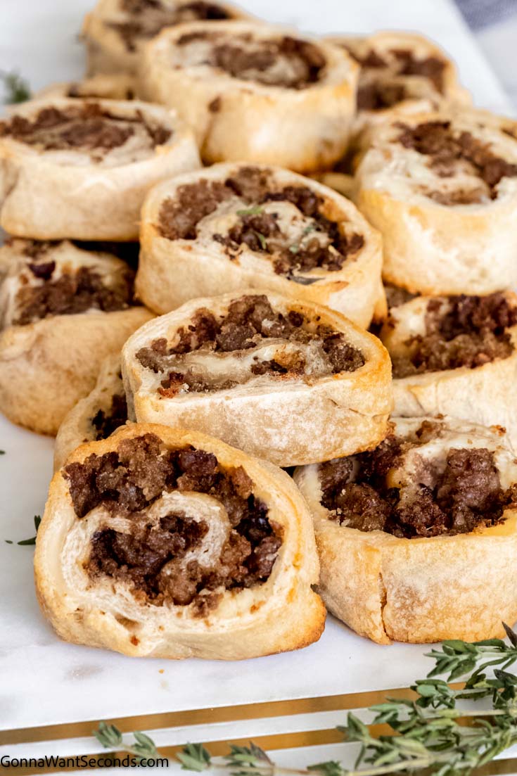 sausage and cream cheese pinwheels on a marble serving board