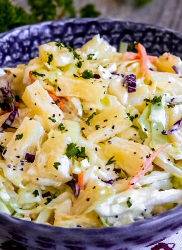 pineapple coleslaw in a blue bowl