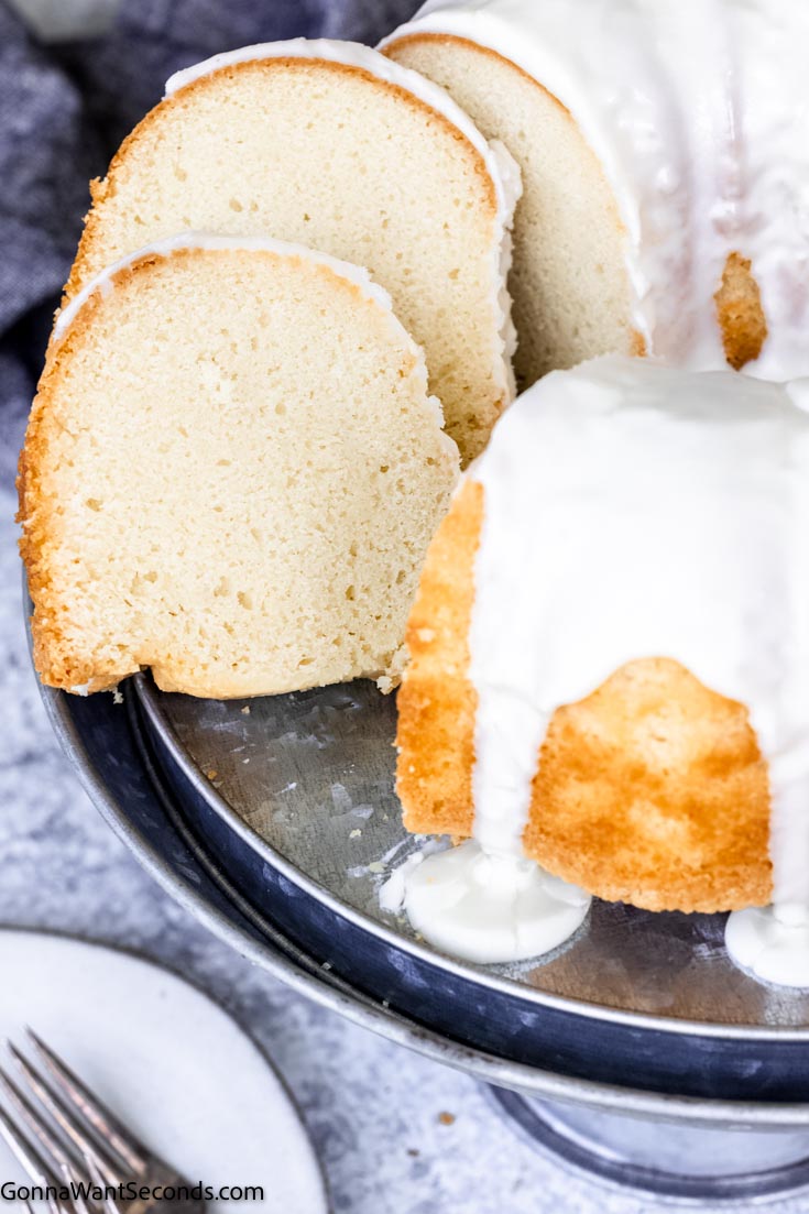 This buttermilk pound cake is very tender, moist, delicate, and has a buttery flavor with a lovely hint of lemon. #buttermilkcake #poundcake whole buttermilk pound cake with slices