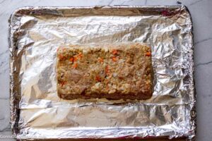 Step 8 how to make old fashioned chicken meatloaf, Firmly press the meatloaf mixture into the prepared pan. Invert the pan onto the foil-lined baking sheet.
