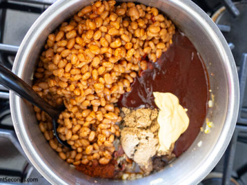 Step 4 how to make cowboy baked beans, Add canned beans, BBQ sauce, sugar, chili powder, diced chiles, Creole mustard, liquid smoke, hot sauce;