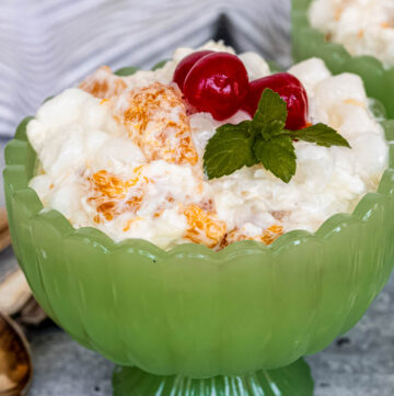 5 cup salad with cherries on top in a green sherbet glass