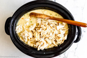 Step 5 how to make crock pot chicken and noodles using reames noodles, Return the chicken to the crockpot. Add the noodles and vegetables.