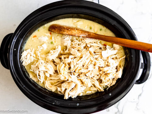Step 5 how to make crock pot chicken and noodles using reames noodles, Return the chicken to the crockpot. Add the noodles and vegetables.