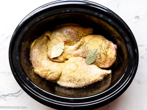 Step 1 how to make crockpot chicken and noodles, Arrange chicken breast in a single layer in the bottom of a large crockpot. Sprinkle the chicken with the seasonings.