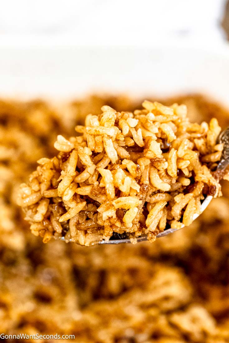 Say hello to a savory, rich side dish called stick of butter rice. You won't believe how delicious a 4-ingredient recipe can be! #rice #sidedishes Serving spoon scooped a portion of Stick of butter rice