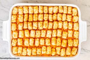 Step 7 how to make cracked out chicken tater tot casserole, Arrange the tater tots in a single layer. Bake