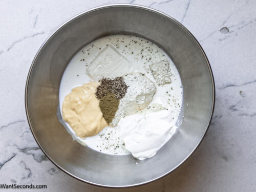 Step 2 how to make easy cracked out chicken tater tot casserole, In a mixing bowl, whisk together the cream of chicken soup, cream cheese, milk, sour cream, thyme, and seasonings.