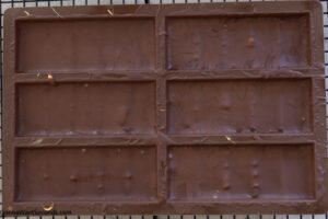 Step 2 how to make Dubai chocolate bar, Pour a thin layer of the melted chocolate into the bar mold. Refrigerate.