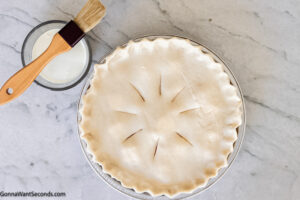 Step 7 how to make peach pie with premade crust, Arrange the top of the crust, brush it with heavy cream. Sprinkle with coarse sugar and bake. If it's browning too quickly cover it with the prepared crust shield on top.
