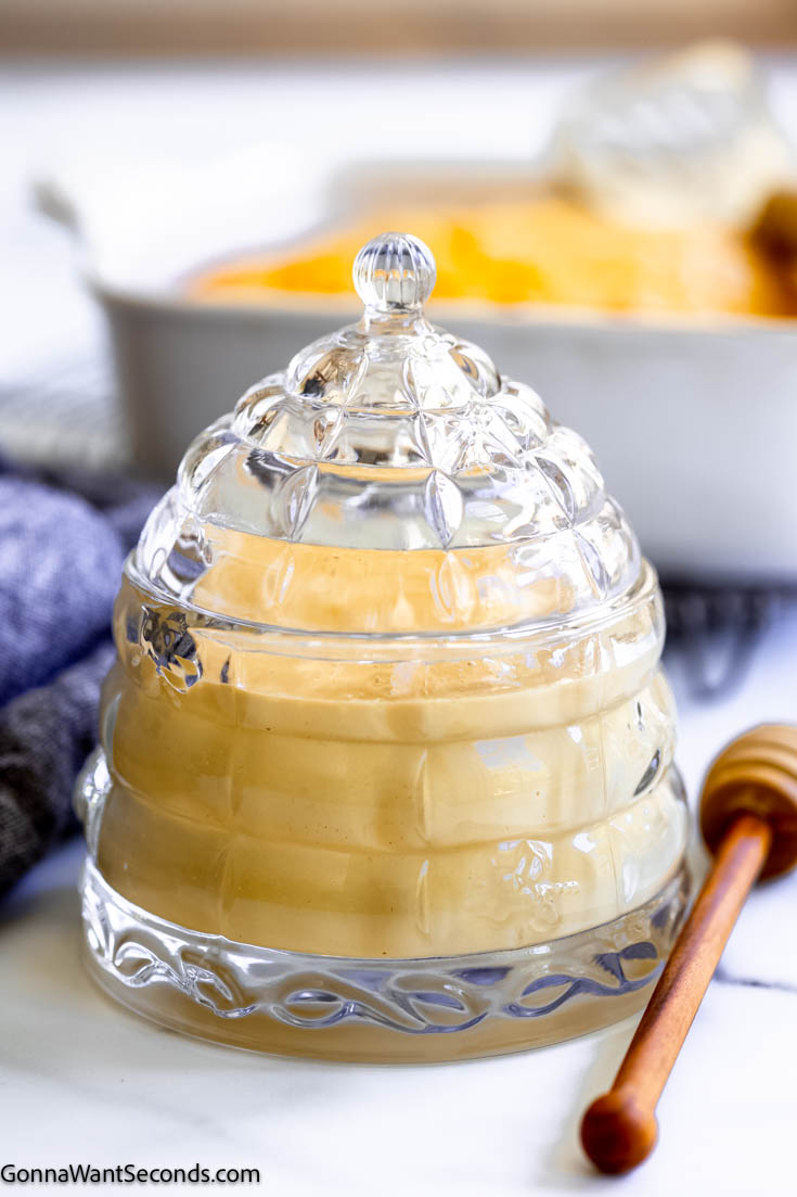 Whipped honey has a toffee-like texture that's soft-spreadable, making it a new way to enjoy cornbread, biscuits, and even plain toast! #whippedhoney #honey whipped honey in a glass honey jar
