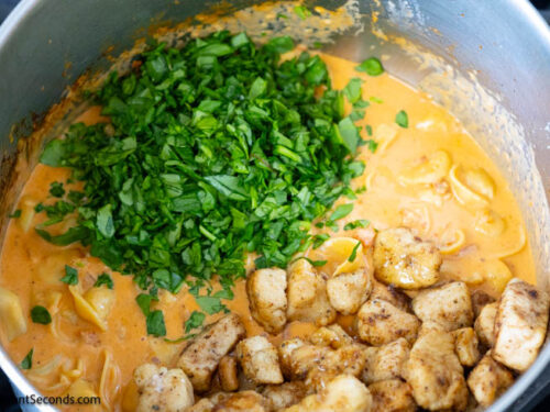 Step 9 how to make marry me chicken with tortellini, Add the cooked chicken and spinach. Gently toss until everything is well coated.
