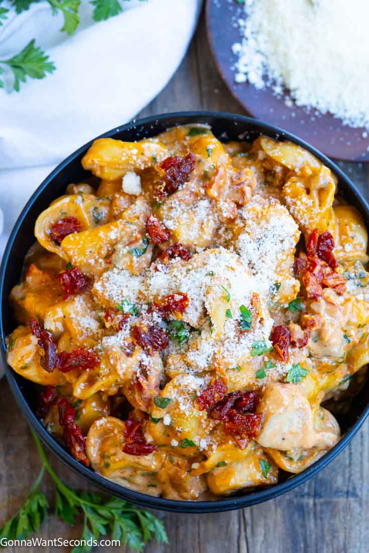 This marry me chicken tortellini has a creamy, garlicky, sun-dried tomato and spinach sauce packed with juicy breaded chicken and soft tortellini. #chickentortellini #marrymechicken marry me chicken tortellini in a bowl