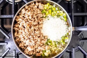 Step 5 how to make sausage rice cream of mushroom casserole, Add the rice and cooked sausage to the skillet.